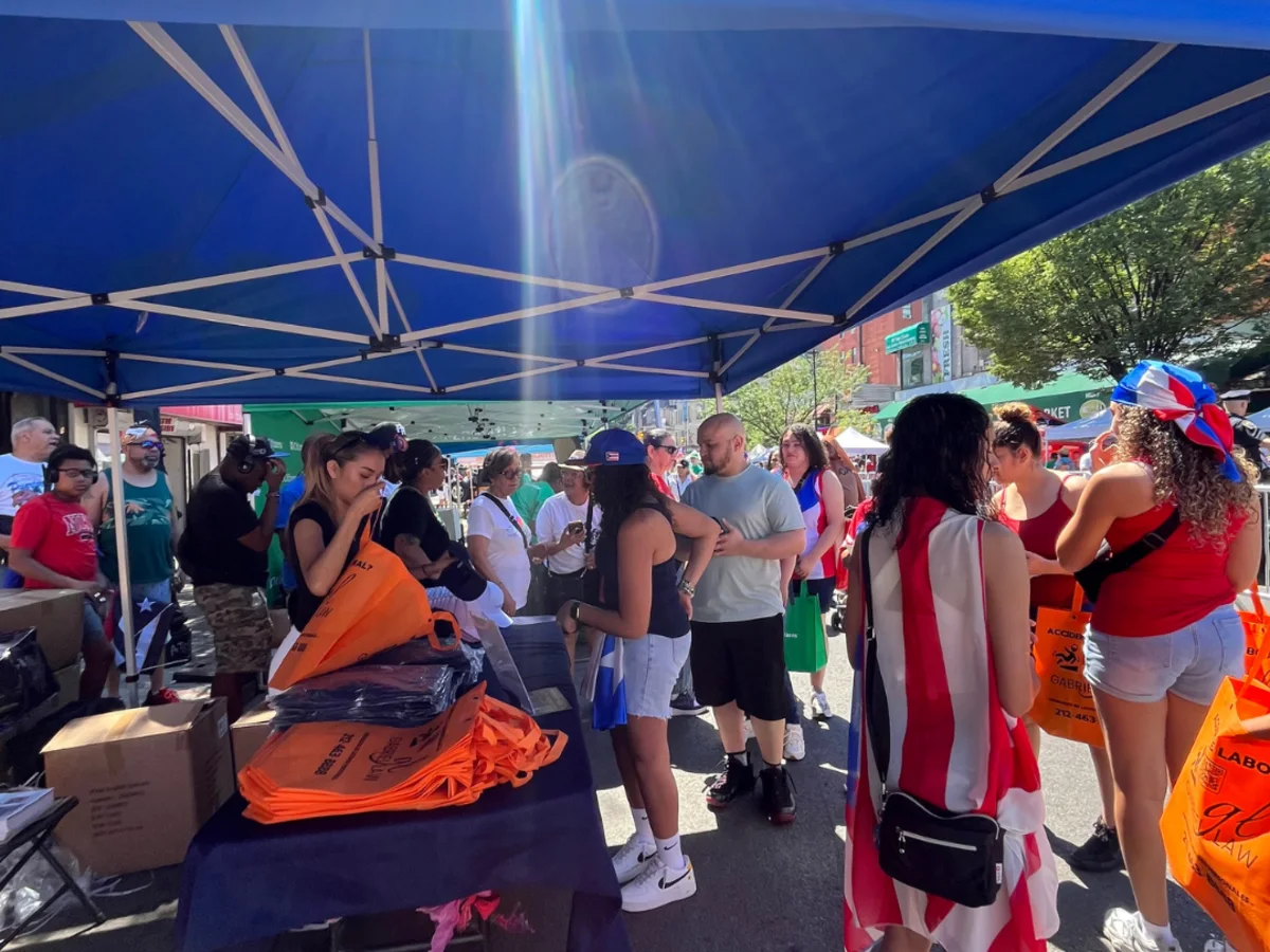 Crowd at the Gabriel Law booth during the 116th Street Festival