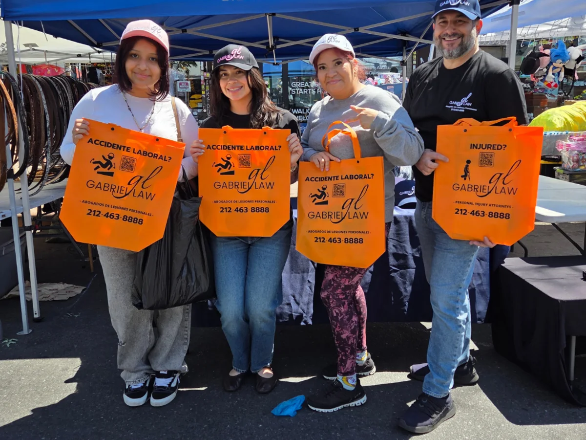 Attendees holding Gabriel Law tote bags at Carnaval de la Cultura Latina